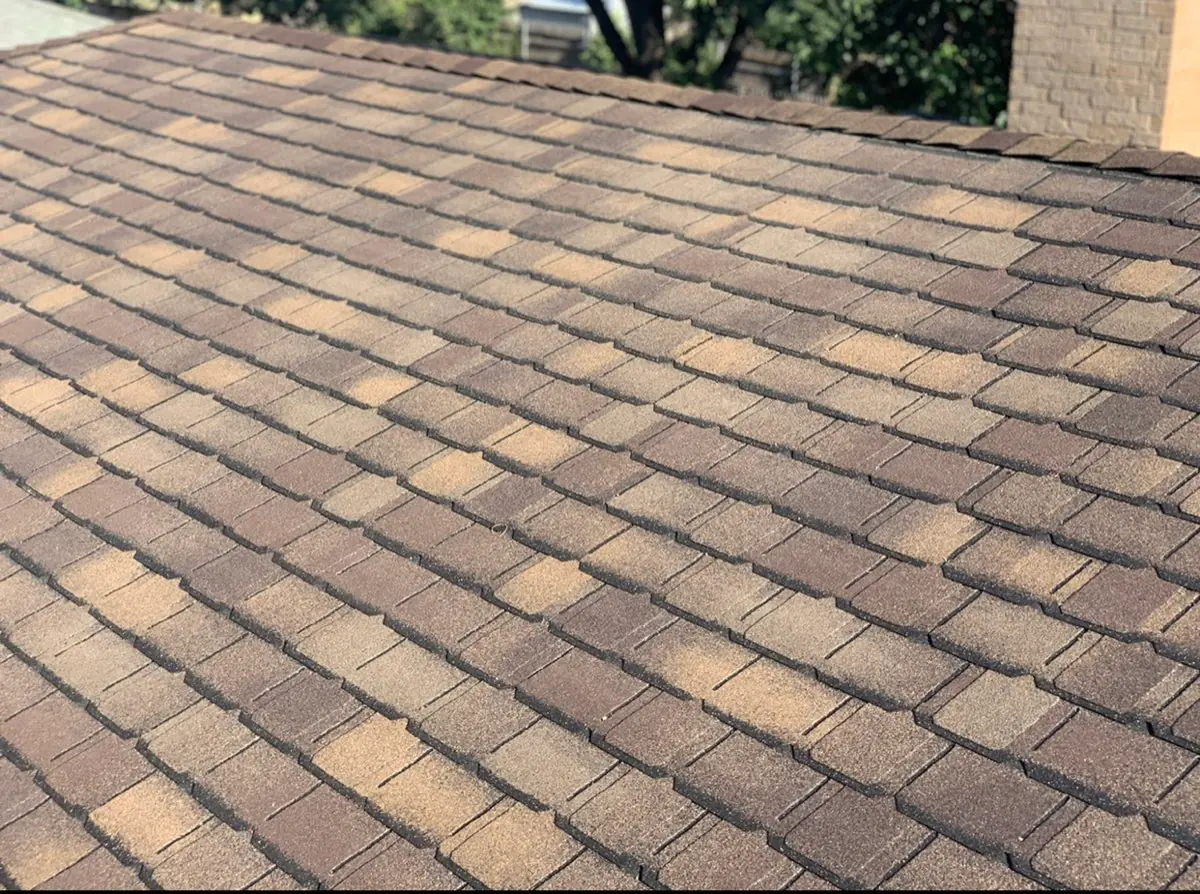 Brown architectural asphalt shingles viewed across a roof slope